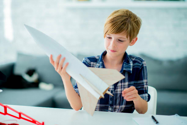 Young boy building model rocket.